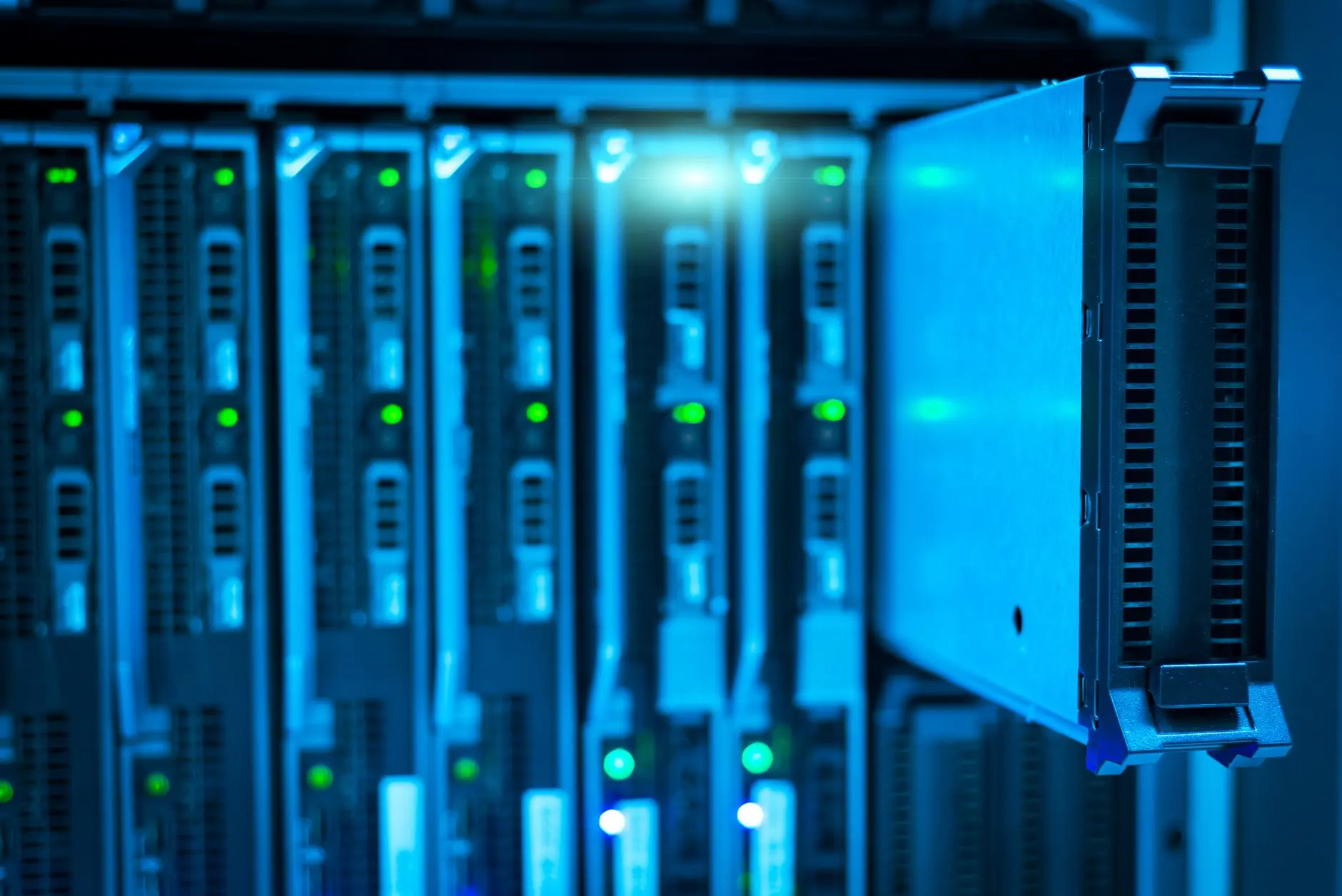 Rows of glowing server racks inside a high-tech modern enterprise data center facility