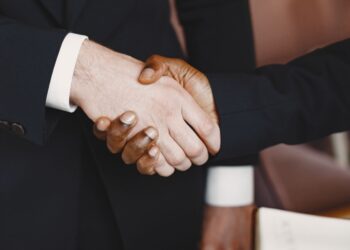 Business executives gathered at an international trade exhibition discussing regional investment opportunities.