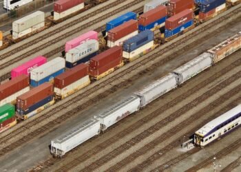 Freight train moving containers through a commercial transit terminal in Turkey logistics hub.