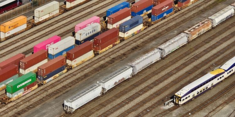 Freight train moving containers through a commercial transit terminal in Turkey logistics hub.